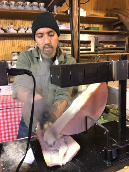 Vendor making sandwich with raclette cheese at Chicago's Christkindlemarket
