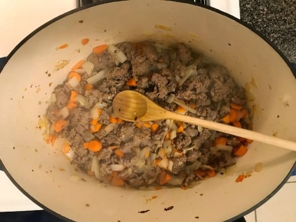 Cooked Italian sausage with carrots and onions and garlic

