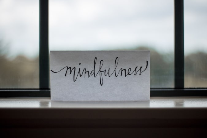 mindfulness written on paper on window sill