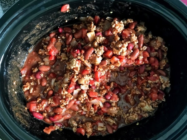 Slow cooker turkey chili ingredients stirred