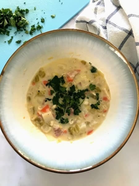 Swiss Barley Soup in a bowl topped with chopped parsley