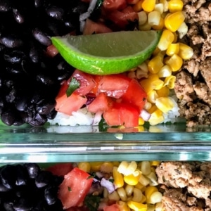 easy healthy burrito bowl with black beans, tomatoes, cauliflower rice, corn, and ground turkey.