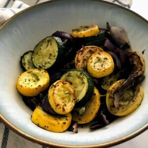 roasted squash and red onions in a bowl.
