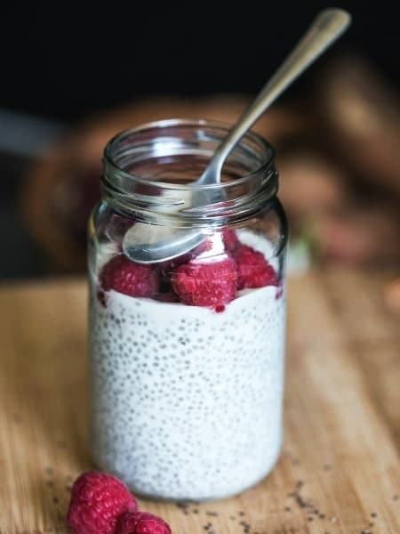 top 5 healthy recipes and nutrition posts in 2021, chia seed pudding topped with raspberries in a jar