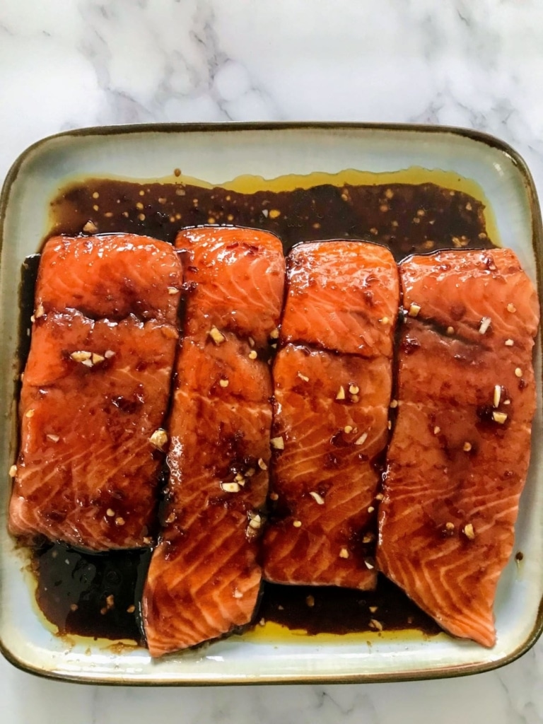 raw salmon on a plate covered with marinade