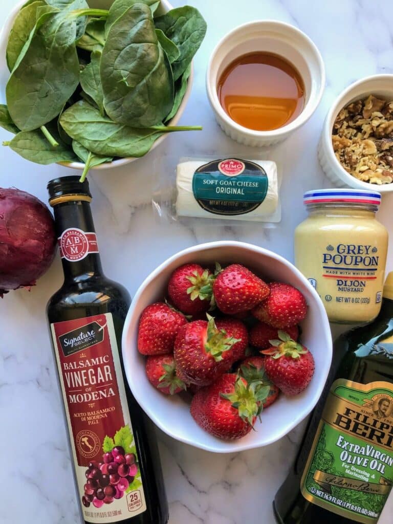 ingredients baby spinach, maple syrup, chopped walnuts, red onion, balsamic vinegar, strawberries, goat cheese, Dijon mustard, olive oil.