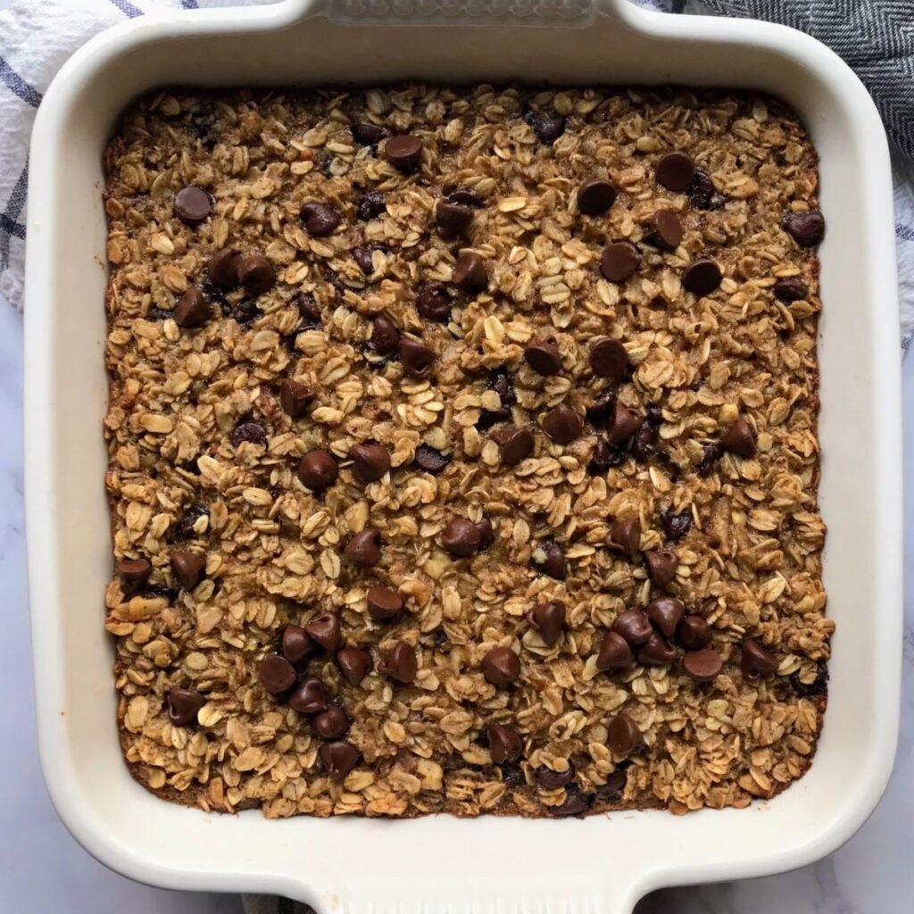 baked chocolate chip oatmeal in a white baking dish.
