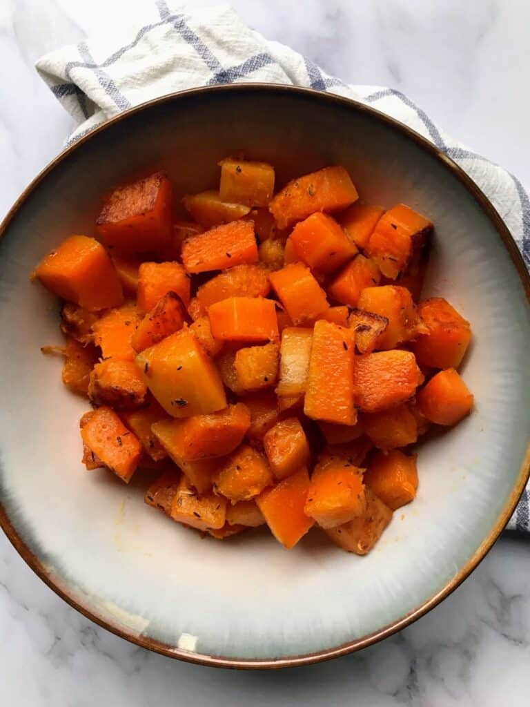 sauteed butternut squash cubes in a bowl.