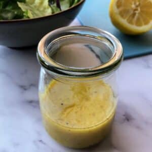 Lemon dijon mustard dressing in a glass jar.