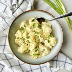 spring onion potato salad in a bowl.