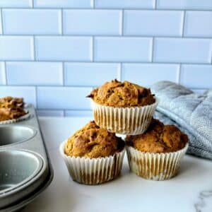 low FODMAP pumpkin muffins stacked on top of each other.